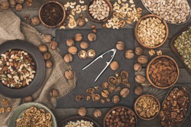 various nuts on wooden table top clipart