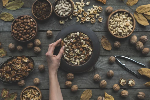 Assorted nuts and autumn leaves — Stock Photo, Image