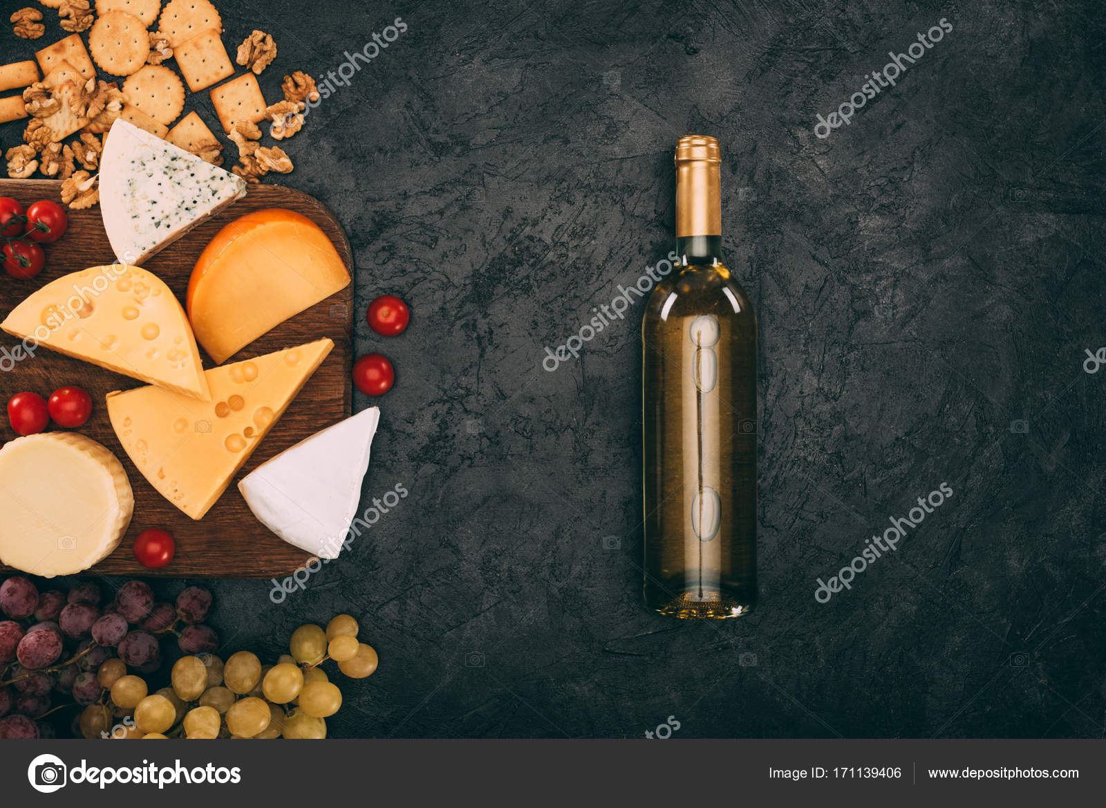 Assorted cheese and bottle of wine — Stock Photo © VadimVasenin 171139406
