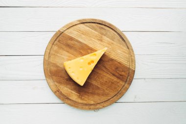 piece of cheese on cutting board clipart