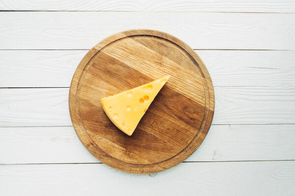 piece of cheese on cutting board