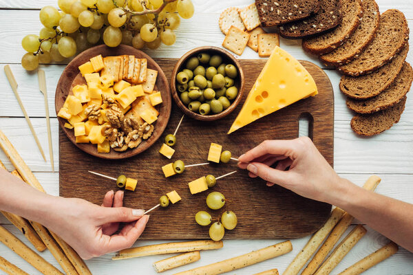 women making canapes with cheese