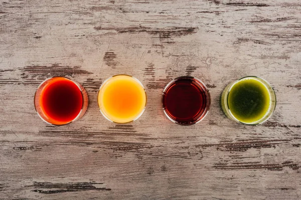 Glasses of juice on wooden tabletop — Stock Photo, Image