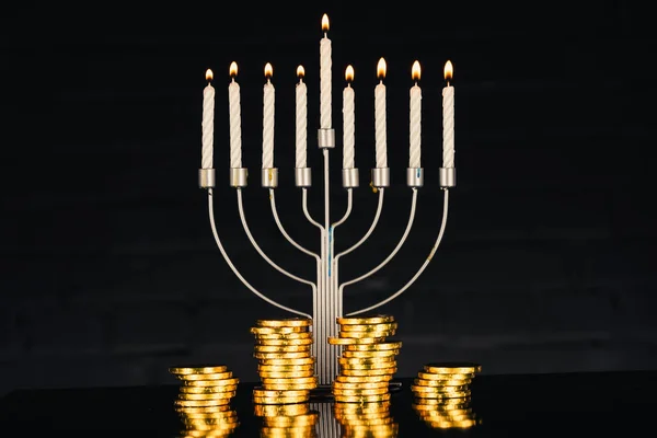 Menorah, candles and coins — Stock Photo, Image