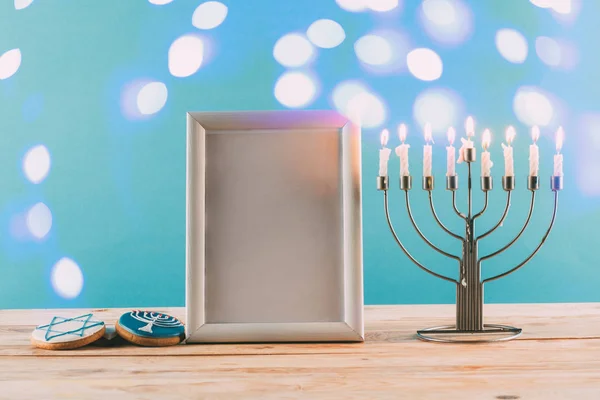 Frame, menorah and cookies for hanukkah — Stock Photo, Image