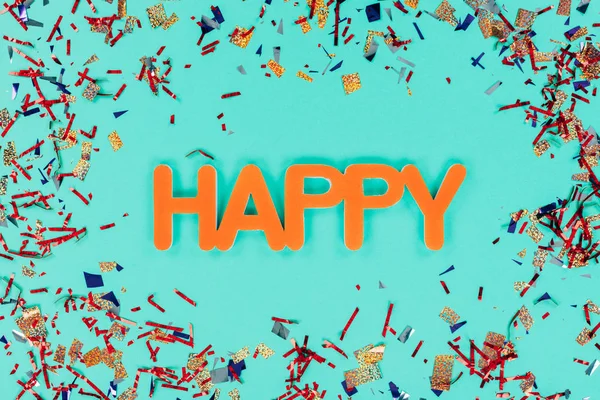 Happy sign surrounded with confetti — Stock Photo, Image