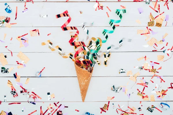 Confetti spilling out waffle cone — Stock Photo, Image