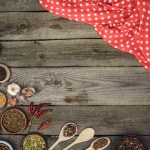 Red tablecloth and different spices