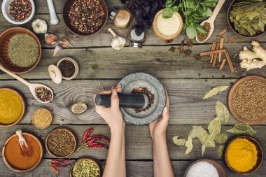 woman grinding pepper with pestle and mortar clipart