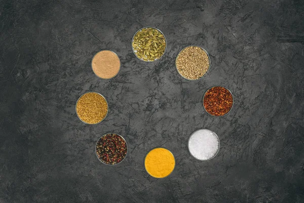 Round of glass bowls with different spices — Stock Photo, Image