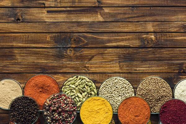 different spices in glass bowls