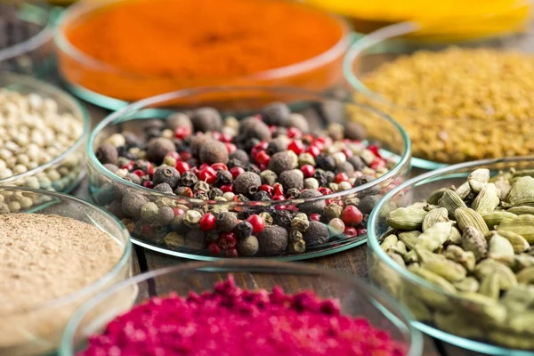 Glass bowls with different spices — Stock Photo, Image