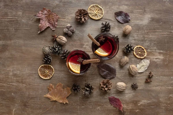 Mulled wine among pine cones and nuts — Stock Photo, Image