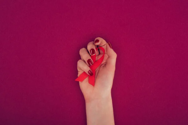 Hand with aids ribbon — Free Stock Photo
