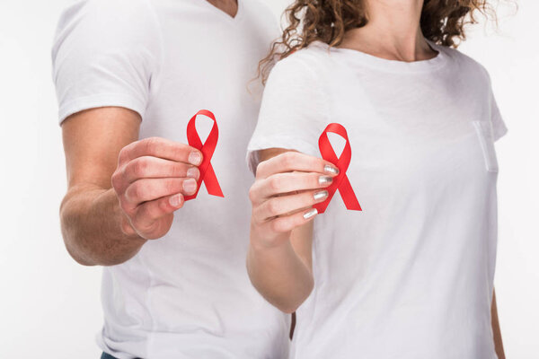 couple holding red aids ribbons
