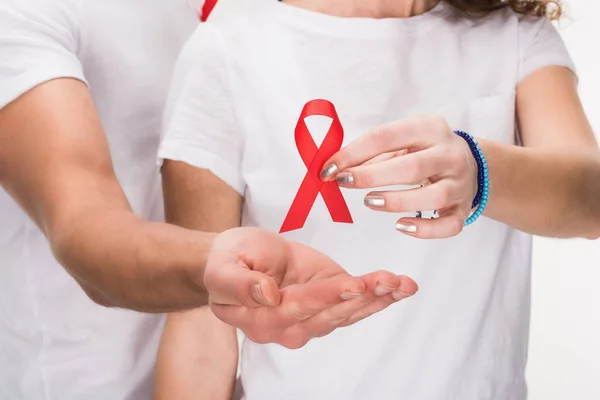 Couple holding red aids ribbon — Stock Photo, Image