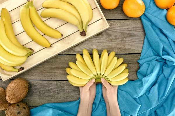 Bunch of bananas in hands — Stock Photo, Image