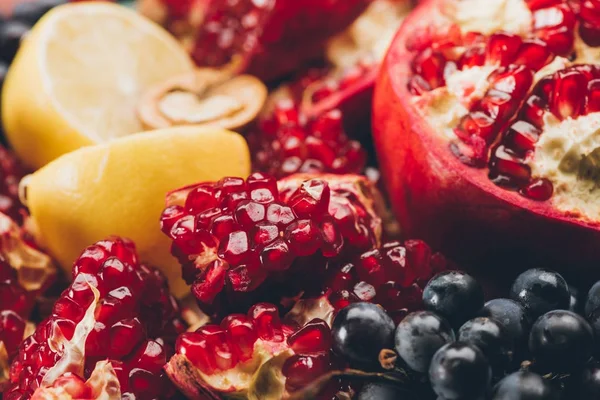 Pomegranate with lemon and grapes — Stock Photo, Image