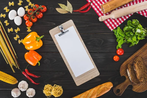 Sheet of paper on clipboard and ingredients — Stock Photo, Image