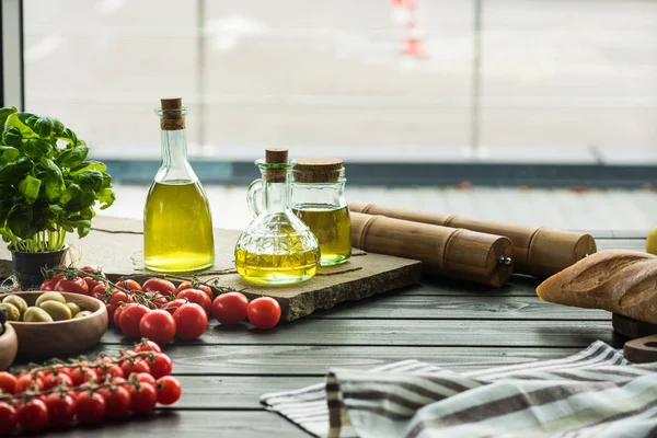 Olive oil bottles with vegetables — Stock Photo, Image