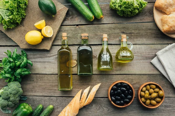 Olive bottles on table — Stock Photo, Image