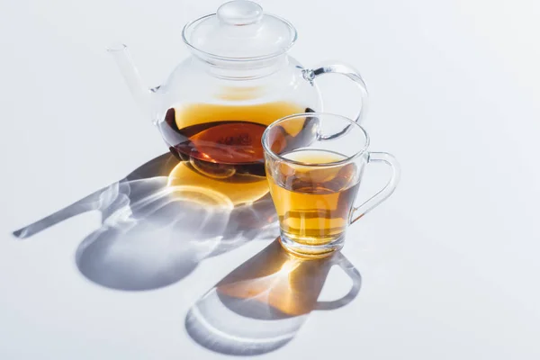 Herbal tea in cup and kettle — Stock Photo, Image