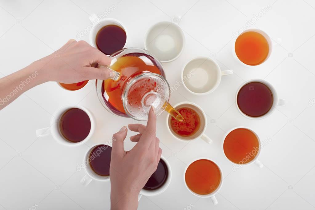 person pouring tea