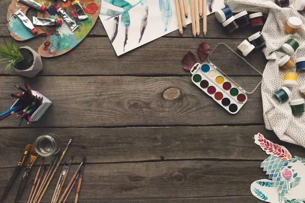 Wooden table with paints and sketches — Stock Photo, Image