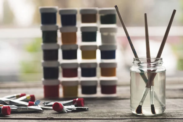 Paint brushes in liquid — Stock Photo, Image