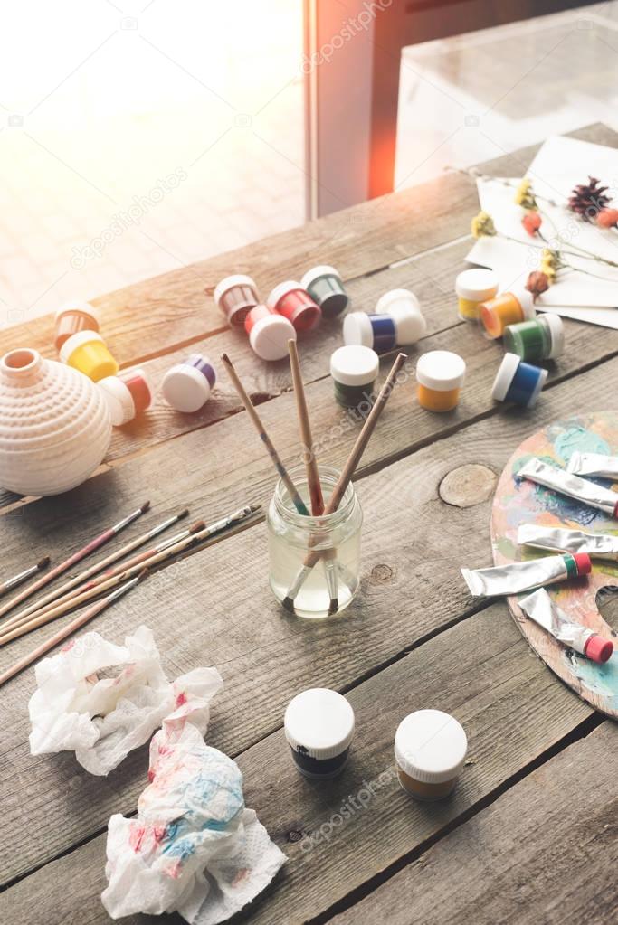 Paint brushes and scattered paints 