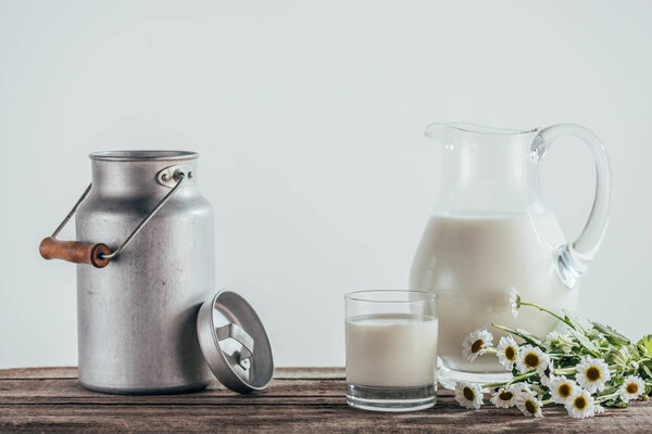 fresh milk in jugs with flowers