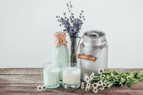 Jug, bottle and two glasses of milk — Stock Photo, Image