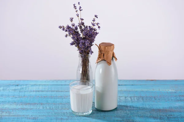 Milk and lavender in vase — Stock Photo, Image