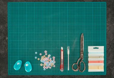 Top view of scale with tools for scrapbooking on gray surface clipart