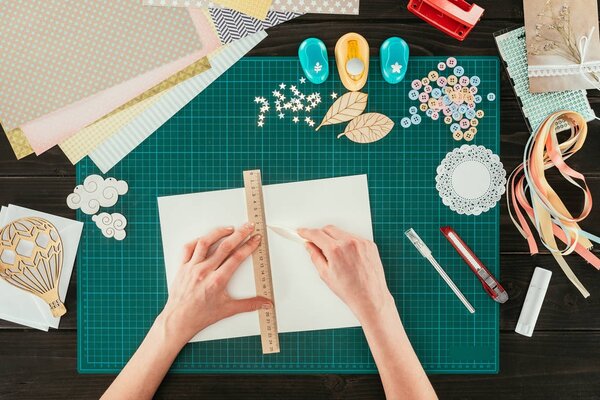 cropped image of woman measuring space for postcard with ruler