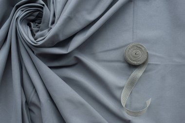 grey folds fabric with cloth roll background