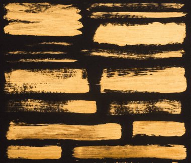 close up view of golden paint strokes on black background clipart