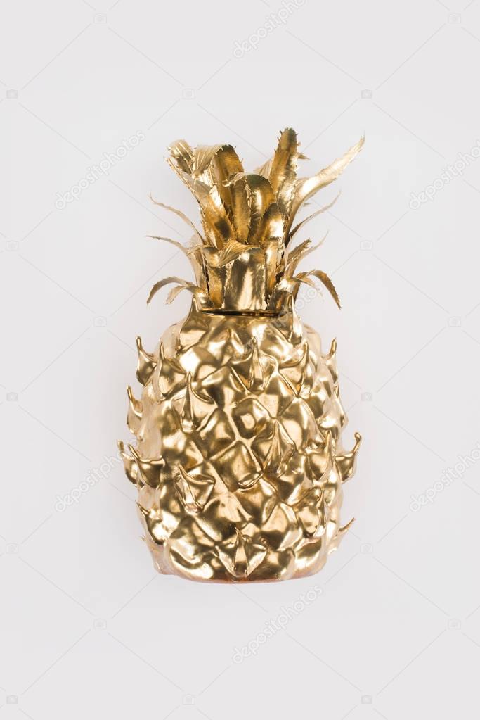 close up view of golden pineapple isolated on grey