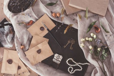 top view of books and envelopes over old fabric clipart