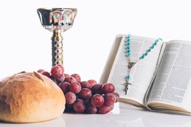 open holy bible, food, chalice and christian cross on white for Holy Communion  clipart