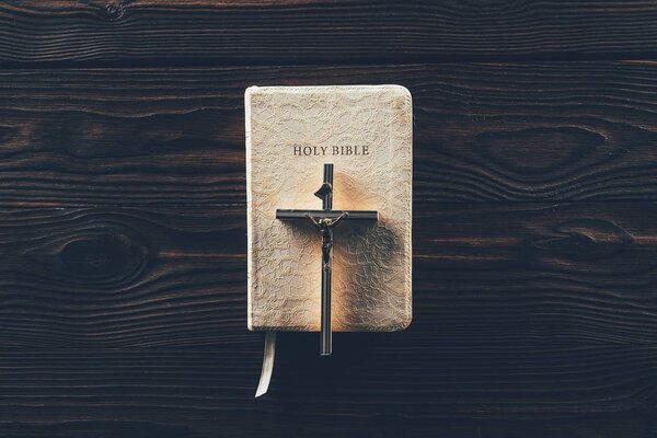 top view of christian cross on closed holy bible