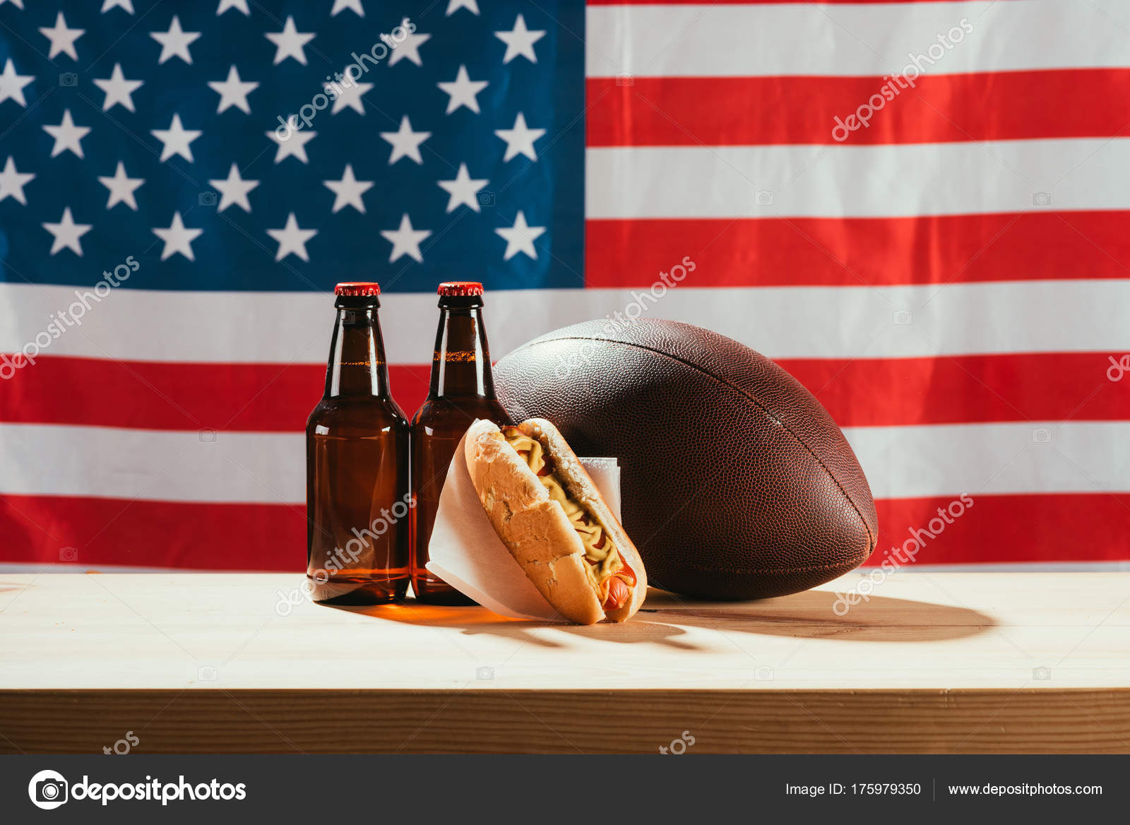 Close View Beer Bottles Hot Dog Rugby Ball Wooden Table Stock Close Up View Of Beer Bottles Hot Dog And Rugby Ball On Wooden Table With Us Flag Behind Photo By Vadimvasenin
