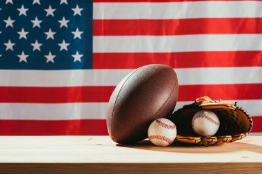 american flag and sport equipment on foreground clipart