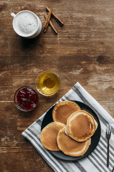 top view of pancakes with coffee cup on wooden table