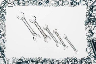 top view of metal wrenches, various bolts and framing nails isolated on white clipart