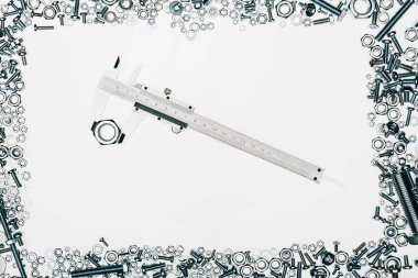top view of arranged various metal engineering details with vernier caliper in middle isolated on white clipart