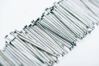 close up view of metal framing nails isolated on white clipart