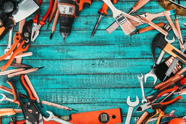 flat lay with various carpentry equipment on blue wooden surface
