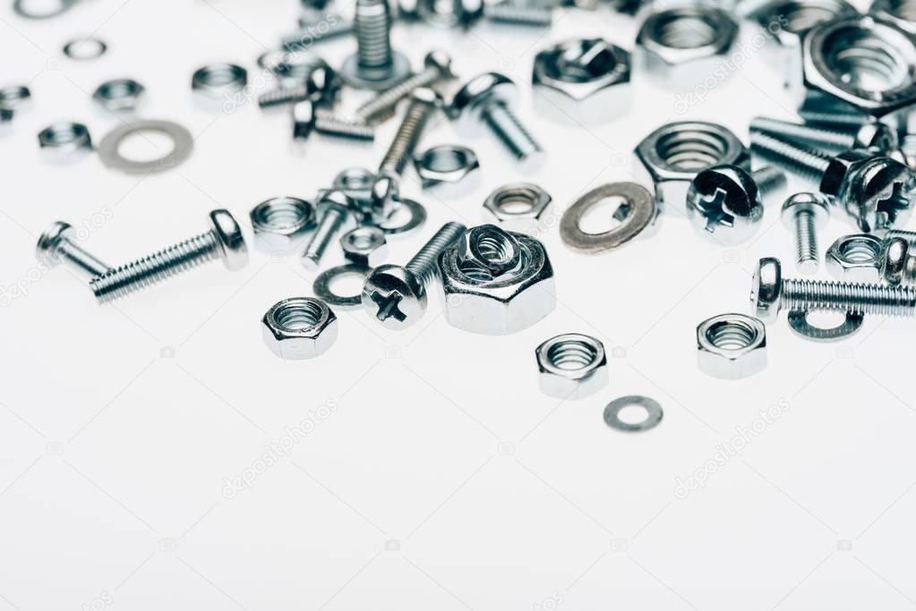 close up view of metal framing nails and capscrews isolated on white
