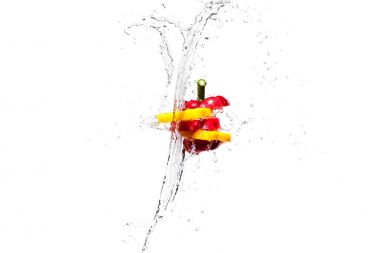 red and yellow bell pepper slices in water splashes isolated on white clipart